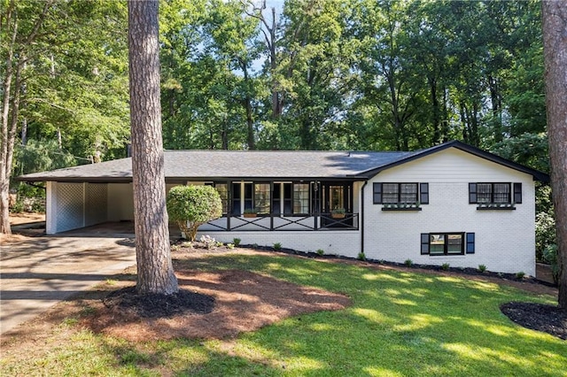 1582 Pine Cir, Austell, GA 30168 - view of front of property featuring brick siding, a front lawn, driveway, covered porch, and a carport