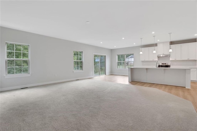 unfurnished living room with light wood-type flooring