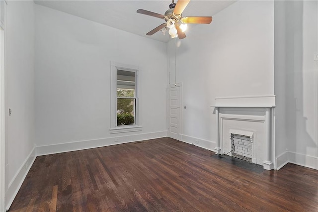 unfurnished living room with ceiling fan and dark hardwood / wood-style floors