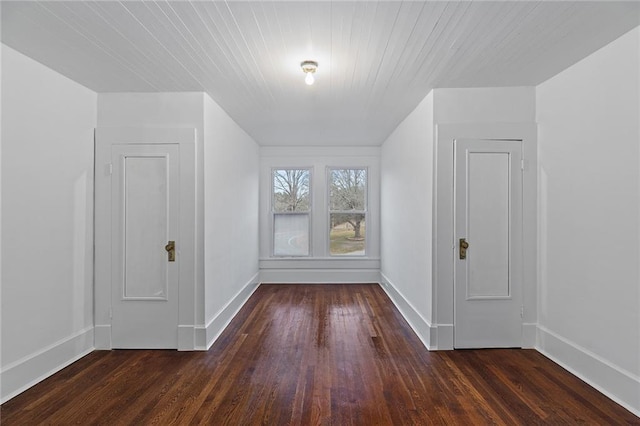 bonus room with dark hardwood / wood-style flooring and wooden ceiling