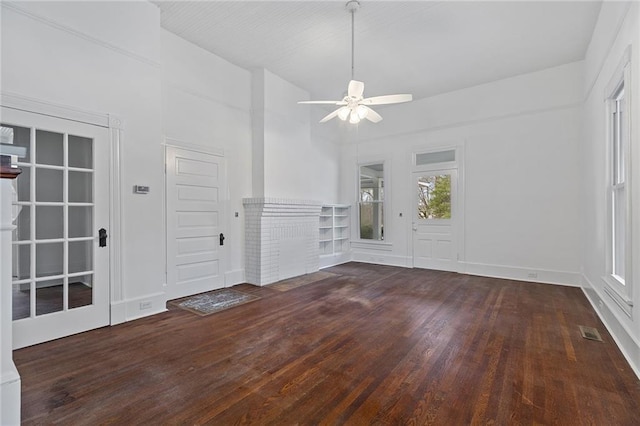 interior space with ceiling fan and dark hardwood / wood-style floors