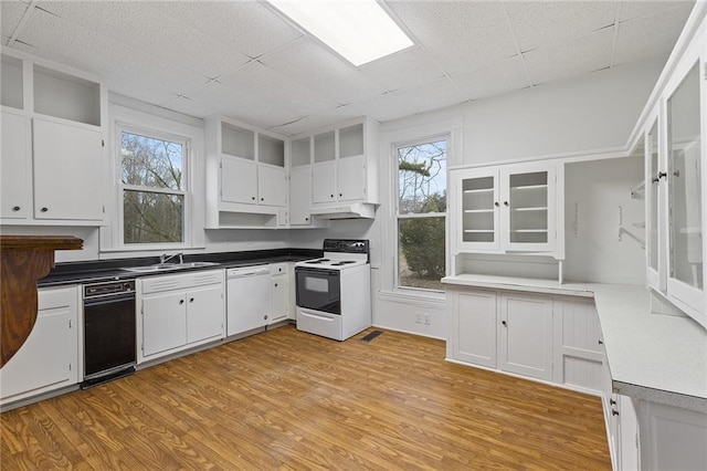 kitchen featuring white cabinetry, a drop ceiling, light hardwood / wood-style floors, and white appliances