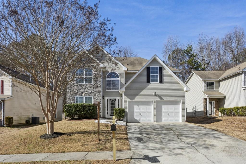 front of property with a garage and central AC