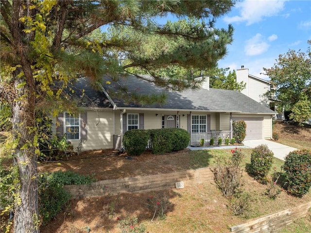 single story home with covered porch and a garage