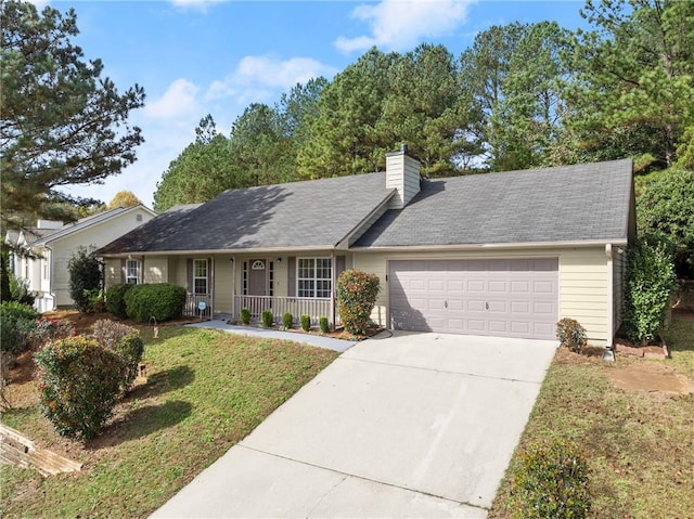 ranch-style house with covered porch, a garage, and a front lawn