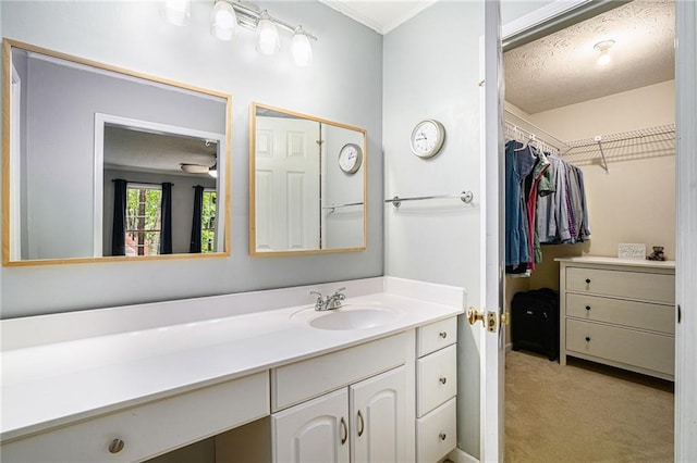 1879 Beaver Dam Ln NE, Marietta, GA 30062 - bathroom with vanity, a walk in closet, and crown molding