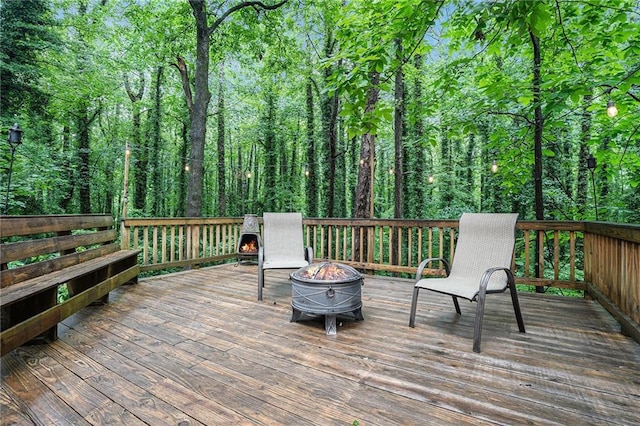 1879 Beaver Dam Ln NE, Marietta, GA 30062 - wooden deck with an outdoor fire pit and a view of trees