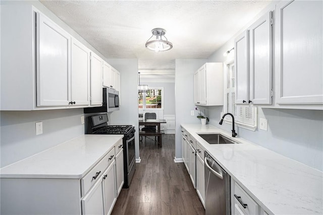 1879 Beaver Dam Ln NE, Marietta, GA 30062 - kitchen with stainless steel appliances, a sink, dark wood-style flooring, white cabinets, and light stone countertops