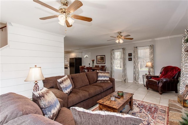 living room featuring ceiling fan, crown molding, and light tile patterned floors