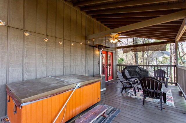 deck with ceiling fan and a hot tub