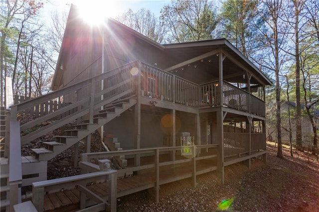 rear view of property featuring a wooden deck