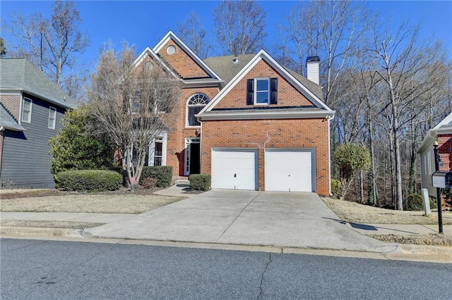 1924 Wilkenson Xing, Marietta, GA 30066 - traditional home with brick siding, an attached garage, driveway, and a chimney