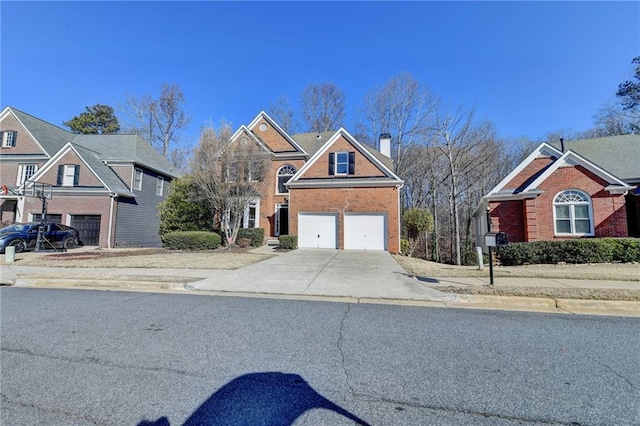 1924 Wilkenson Xing, Marietta, GA 30066 - view of front facade with driveway, an attached garage, a chimney, and brick siding