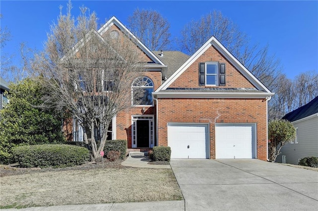 1924 Wilkenson Xing, Marietta, GA 30066 - view of front facade featuring driveway, brick siding, and a garage