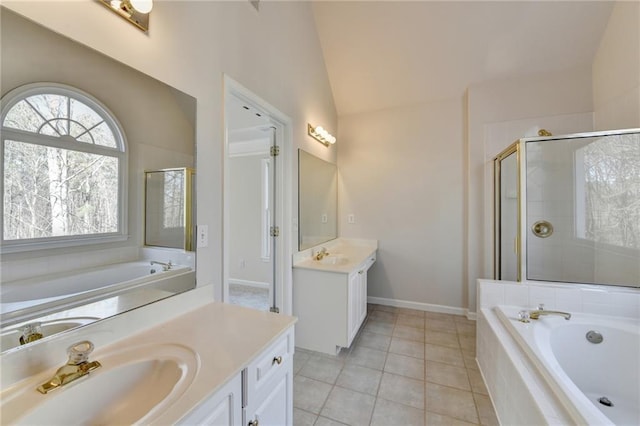 1924 Wilkenson Xing, Marietta, GA 30066 - bathroom featuring two vanities, lofted ceiling, a garden tub, a shower stall, and tile patterned flooring