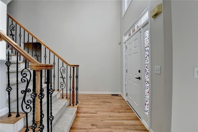 1924 Wilkenson Xing, Marietta, GA 30066 - entrance foyer featuring light wood-style floors, a towering ceiling, stairway, and baseboards