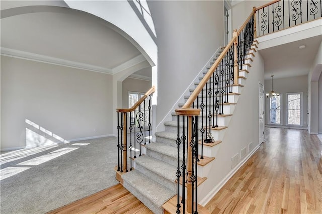 1924 Wilkenson Xing, Marietta, GA 30066 - stairs with arched walkways, wood finished floors, ornamental molding, baseboards, and a chandelier