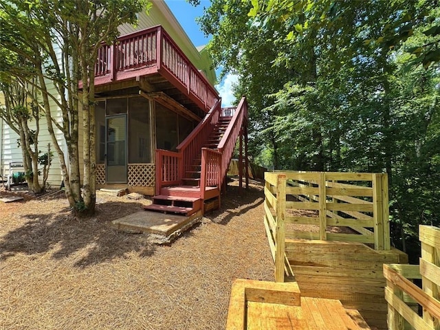 1924 Wilkenson Xing, Marietta, GA 30066 - back of house featuring a wooden deck, a sunroom, and stairway