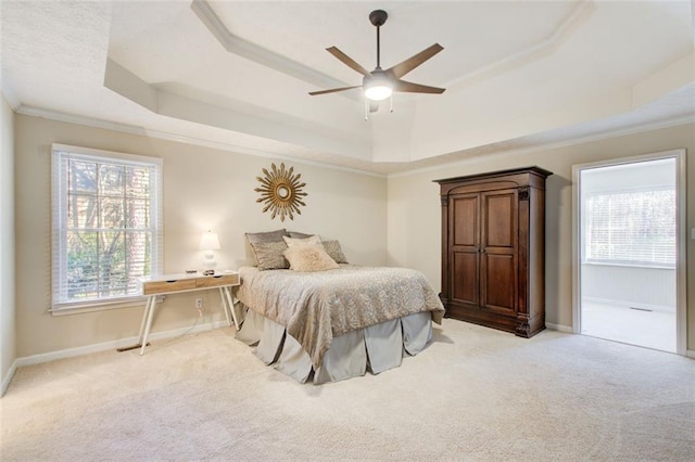 bedroom featuring a raised ceiling, ceiling fan, light colored carpet, and ornamental molding