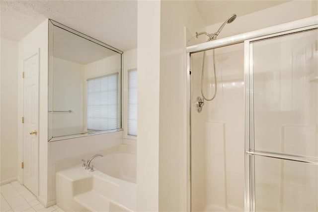 bathroom featuring tile patterned flooring, a textured ceiling, and separate shower and tub