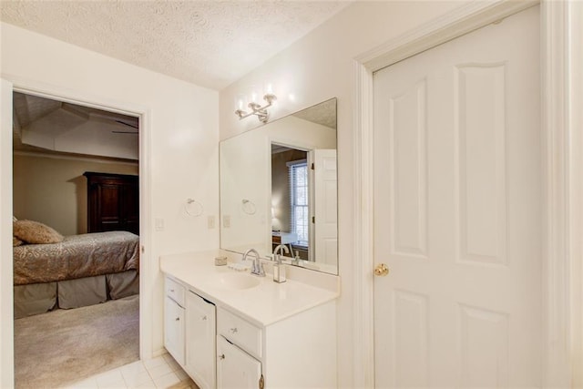 bathroom featuring tile patterned floors, vanity, and a textured ceiling