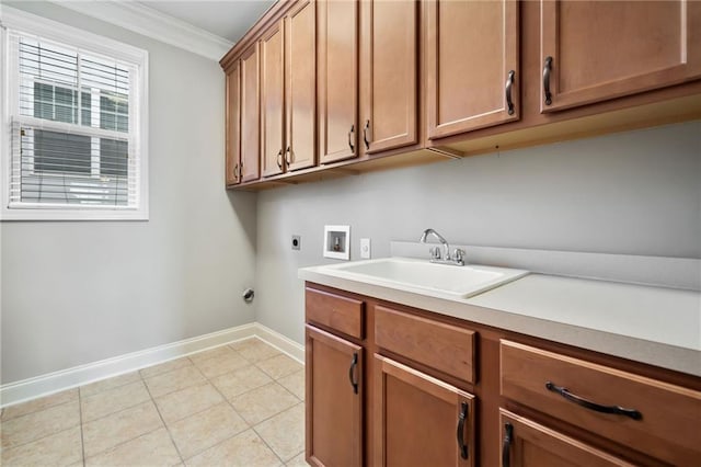 laundry room featuring hookup for an electric dryer, a sink, baseboards, hookup for a washing machine, and cabinet space