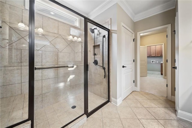 full bath with baseboards, a stall shower, tile patterned flooring, and ornamental molding