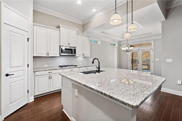 kitchen featuring a sink, white cabinets, dark wood-style flooring, and stainless steel appliances