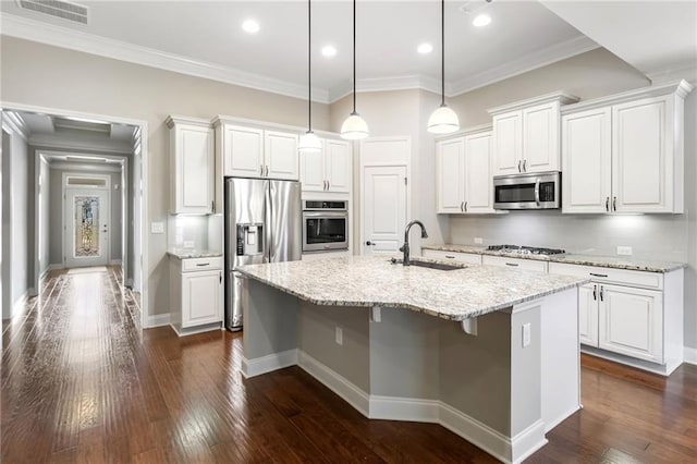 kitchen featuring an island with sink, appliances with stainless steel finishes, a sink, white cabinetry, and visible vents