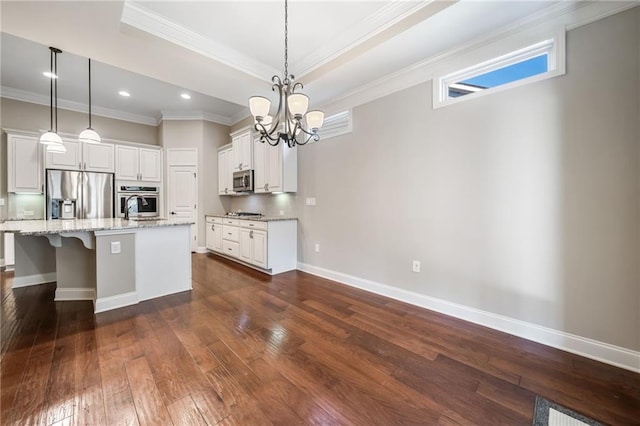 kitchen featuring crown molding, a notable chandelier, stainless steel appliances, and dark wood-type flooring