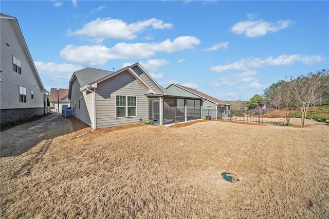 back of property with fence, cooling unit, and a sunroom