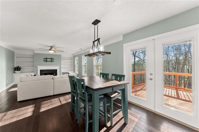 dining room featuring dark hardwood / wood-style flooring, built in features, french doors, and ceiling fan