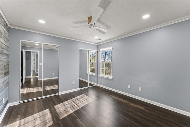 unfurnished bedroom with ceiling fan, ornamental molding, dark hardwood / wood-style flooring, and a textured ceiling