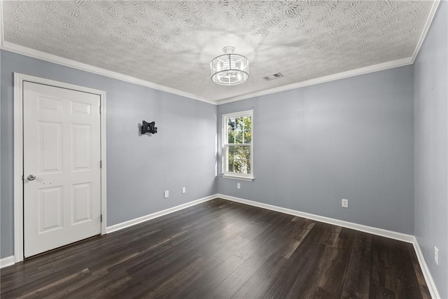 empty room with dark hardwood / wood-style flooring, crown molding, a textured ceiling, and a chandelier