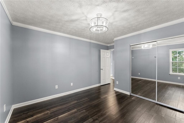 unfurnished bedroom featuring ornamental molding, dark hardwood / wood-style floors, a closet, and a textured ceiling