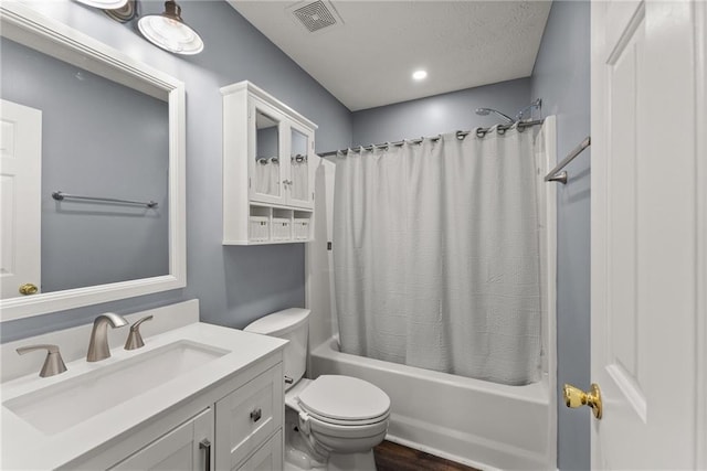 full bathroom featuring hardwood / wood-style flooring, vanity, shower / bath combination with curtain, and toilet