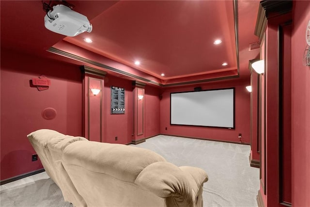 carpeted home theater room with a raised ceiling