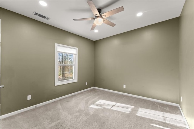 carpeted spare room with ceiling fan