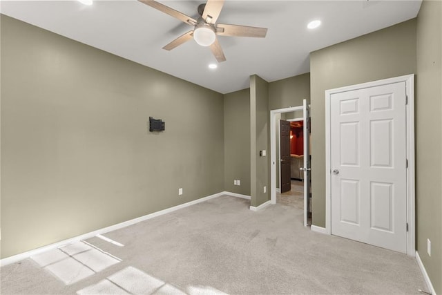 unfurnished bedroom with light colored carpet and ceiling fan