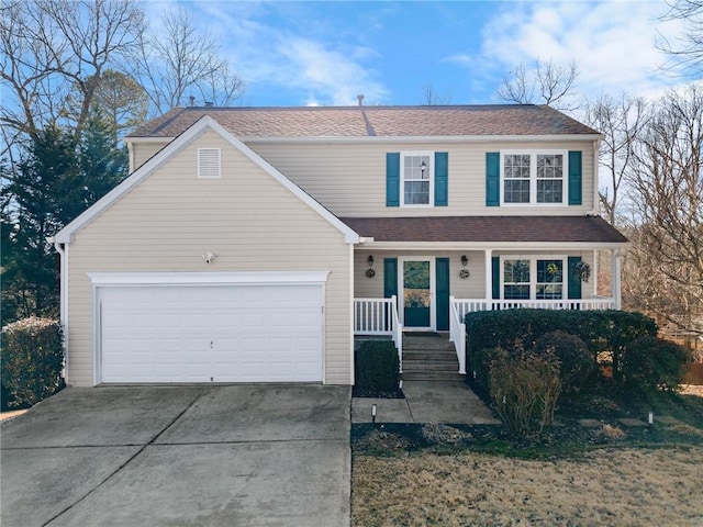 view of property with a garage and covered porch