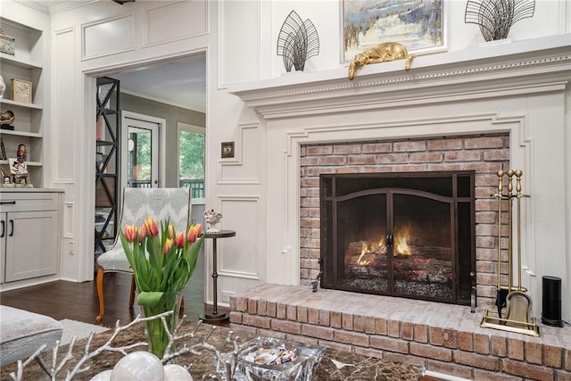 2080 Old Dominion Rd, Atlanta, GA 30350 - detailed view of ornamental molding, a brick fireplace, built in features, and wood finished floors