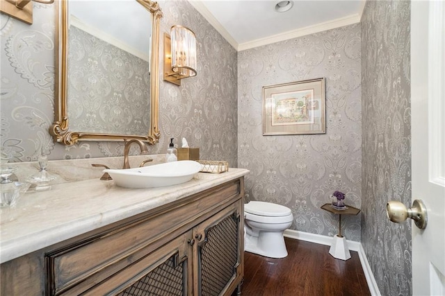 2080 Old Dominion Rd, Atlanta, GA 30350 - bathroom featuring wood finished floors, toilet, vanity, baseboards, and ornamental molding