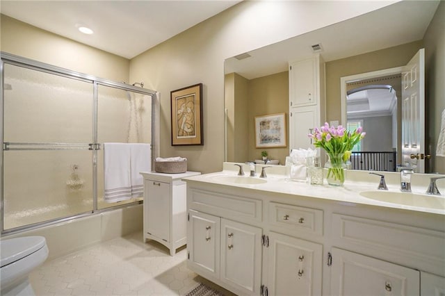 2080 Old Dominion Rd, Atlanta, GA 30350 - full bathroom featuring toilet, double vanity, enclosed tub / shower combo, and tile patterned floors