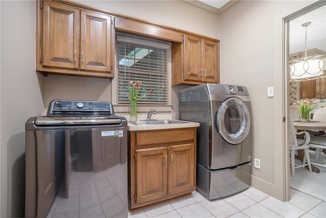 2080 Old Dominion Rd, Atlanta, GA 30350 - washroom featuring washer and dryer, cabinet space, and light tile patterned floors