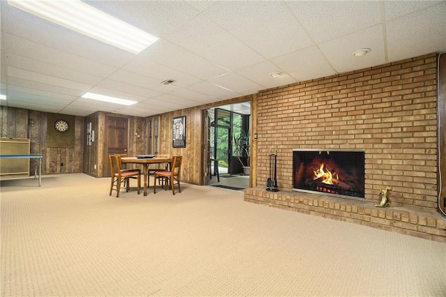 2080 Old Dominion Rd, Atlanta, GA 30350 - carpeted dining area with a paneled ceiling, wood walls, and a fireplace