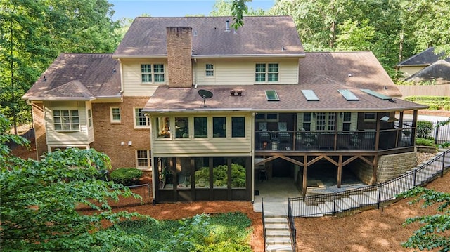2080 Old Dominion Rd, Atlanta, GA 30350 - rear view of property with a chimney, a patio area, a wooden deck, a sunroom, and brick siding