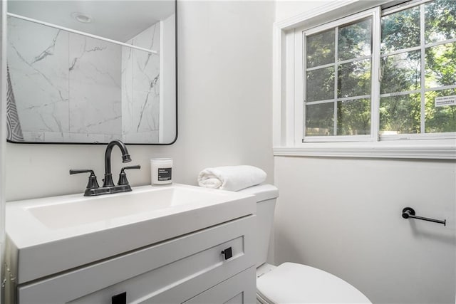 1712 Evans Dr SW, Atlanta, GA 30310 - full bath with healthy amount of natural light, toilet, vanity, and a marble finish shower