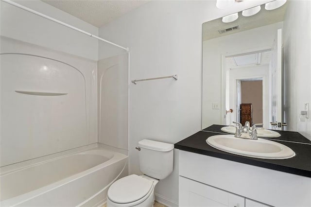 full bathroom featuring vanity, tub / shower combination, a textured ceiling, and toilet