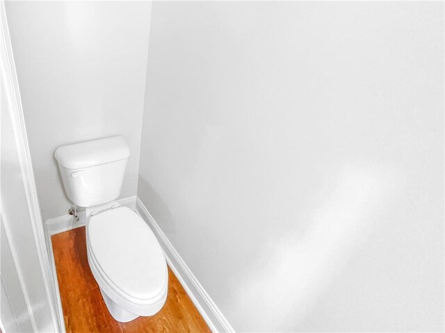 bathroom featuring hardwood / wood-style flooring and toilet