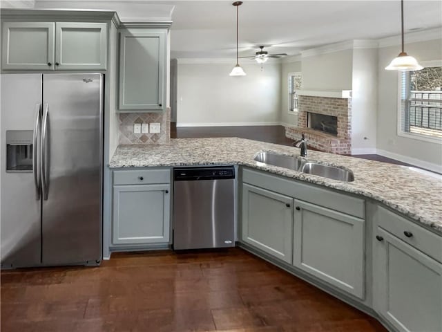 kitchen with ceiling fan, sink, decorative light fixtures, decorative backsplash, and appliances with stainless steel finishes